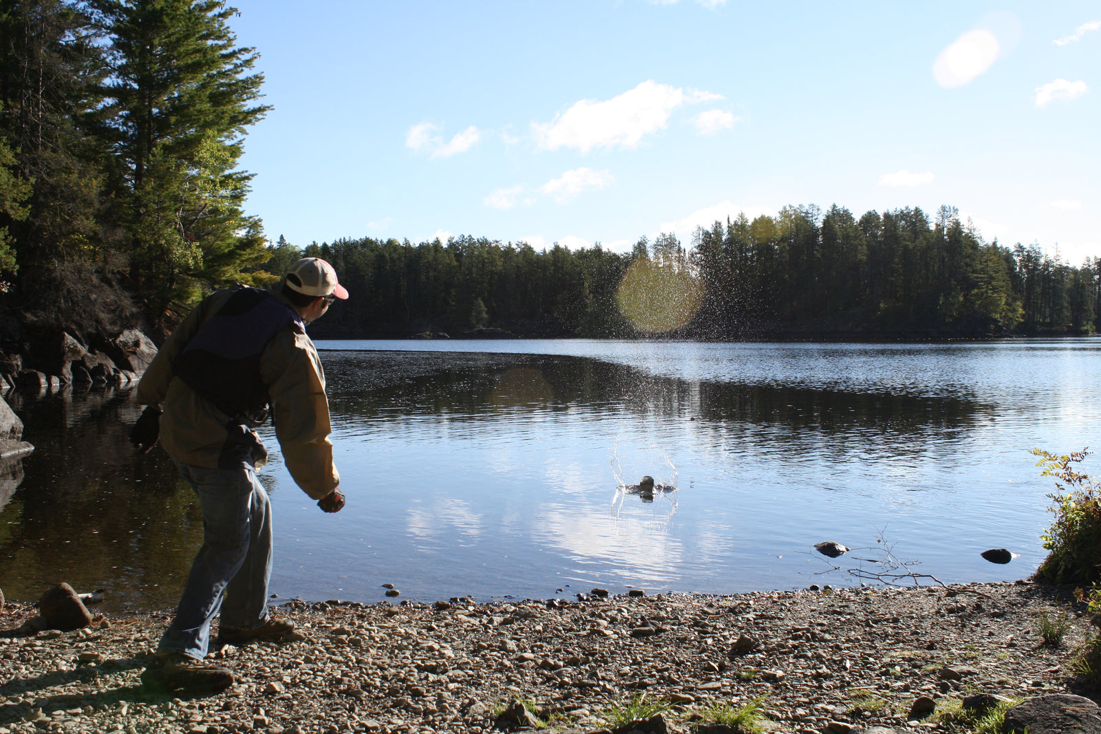 Throwing a stone from a rocky riverbank